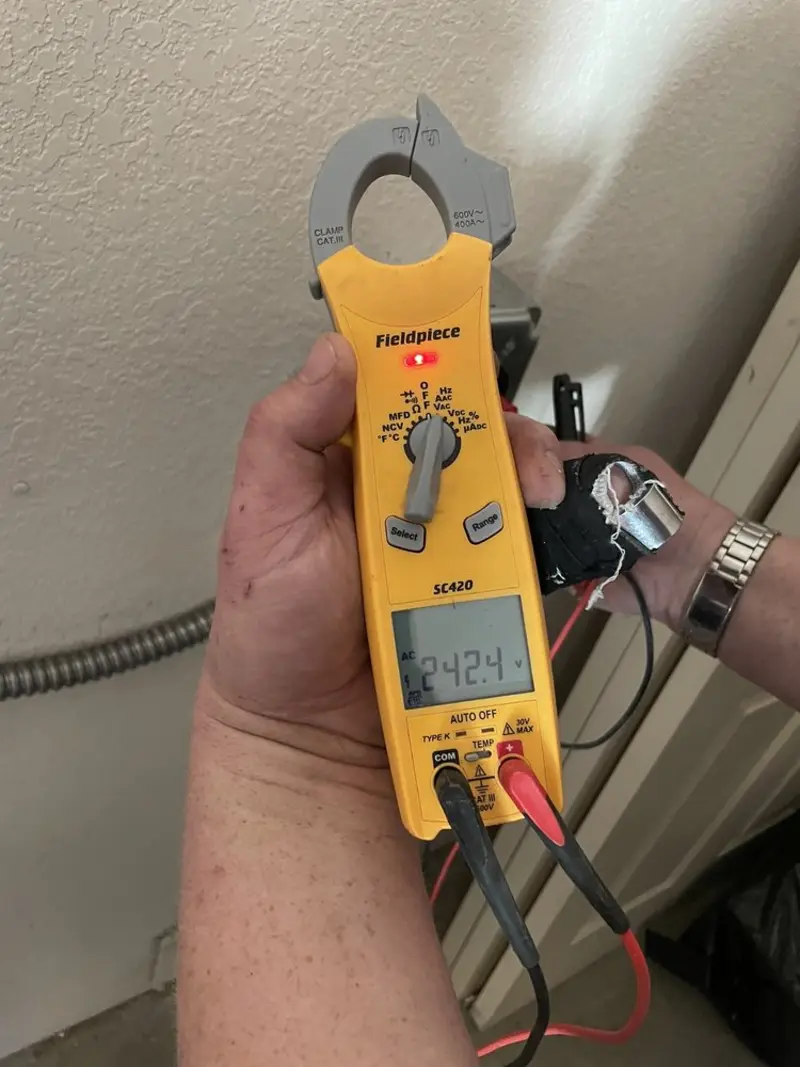 Voltage testing with clamp meter during Recessed Lighting Installation in Trinity